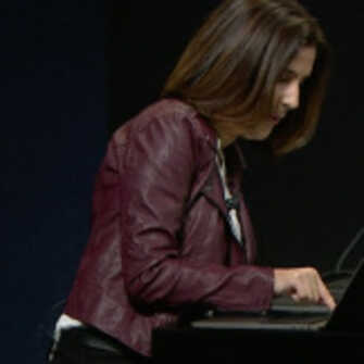 woman struggling to press her finger to macbook touchbar